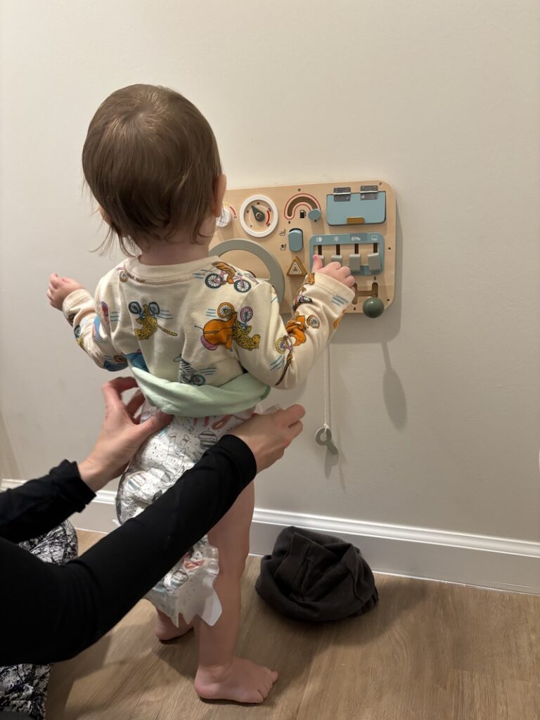 changing toddler's diaper while standing